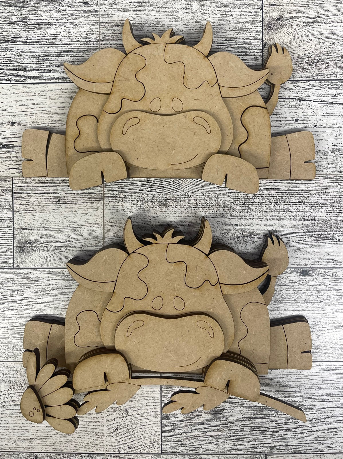 Dairy Cow Shelf Sitters hanging over shelf - set of 2 - unpainted wooden cutouts, ready for you to paint