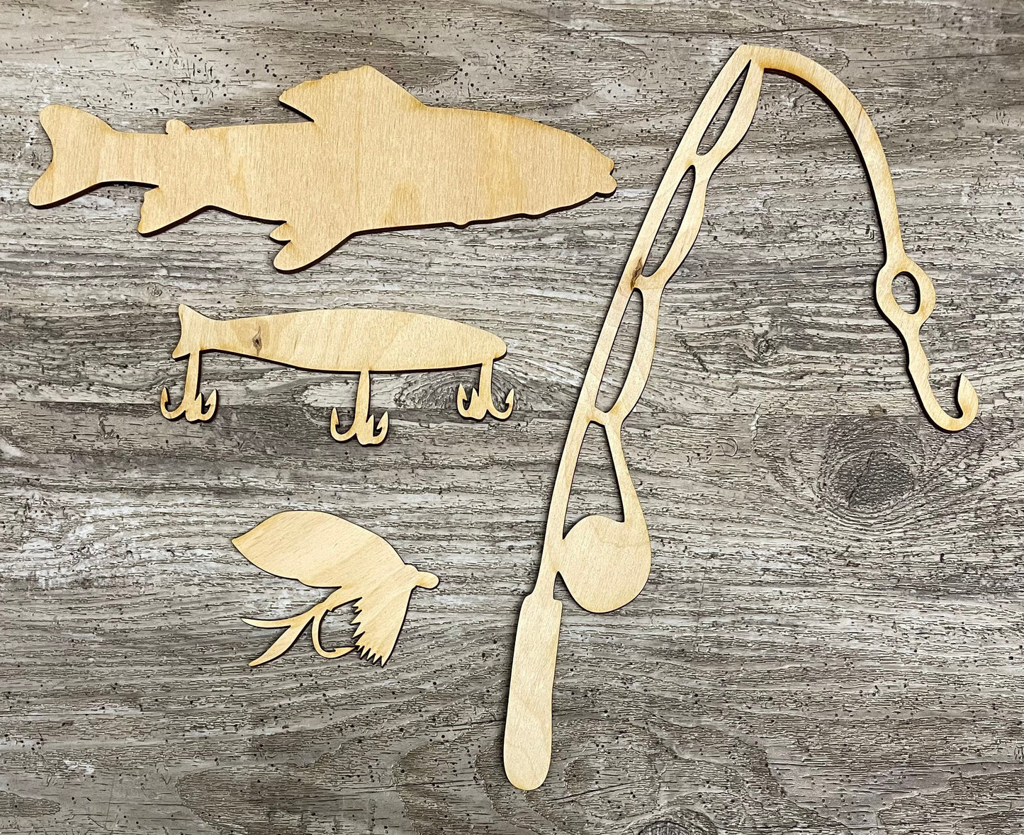 Fishing sign and cutouts, unpainted wooden cutouts